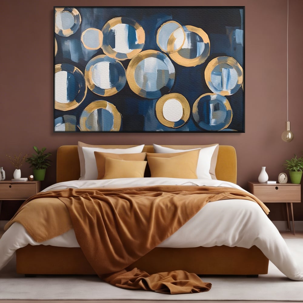Tablou canvas cu pictura abstracta cu cercuri albastre si aurii, in rama de aluminiu negru, pe perete intr-un dormitor